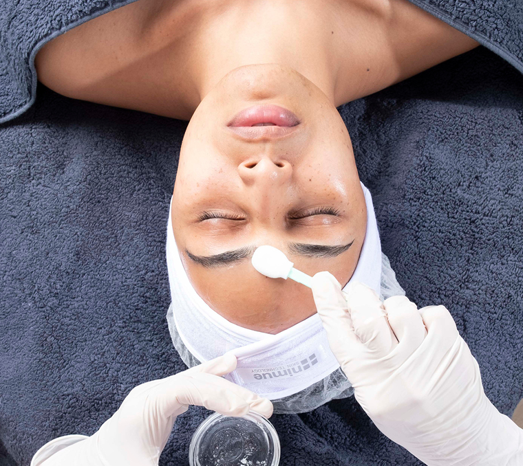 Women receiving a skincare product treatment.